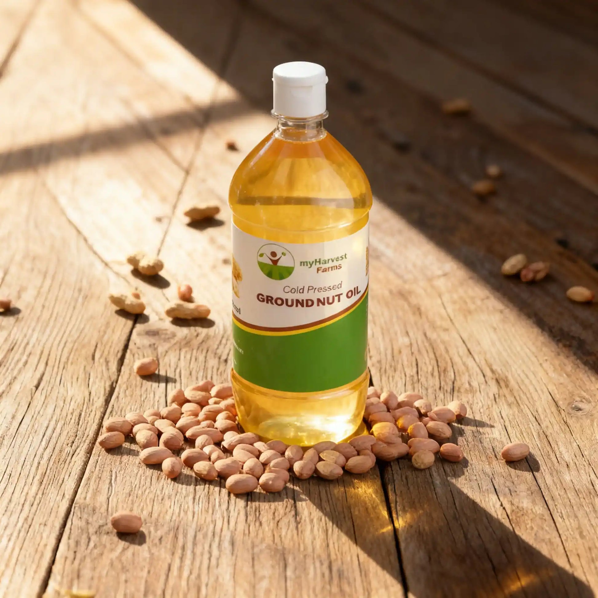 Organic cold pressed groundnut oil bottle with raw peanuts on wooden surface